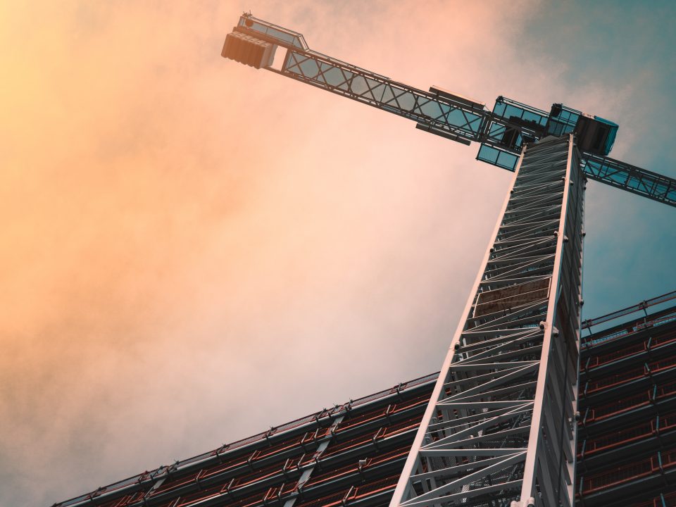 low angle photography of gray tower crane