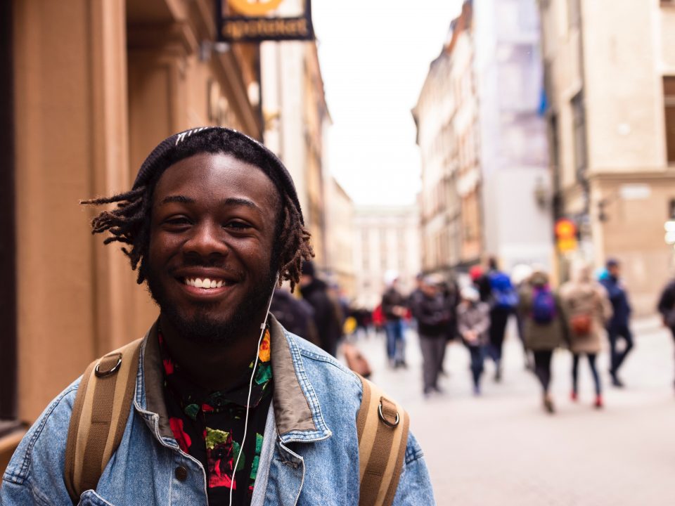 selective focus of man smiling near building