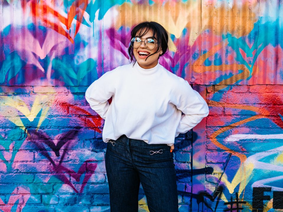 woman standing in front of multicolored wall