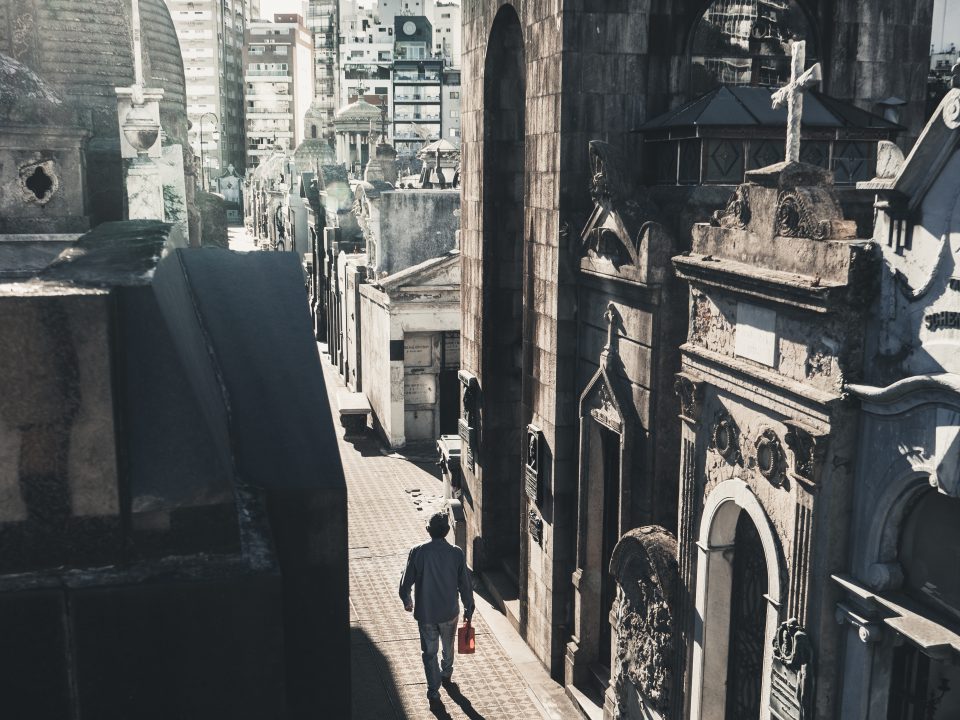 man walking while holding bottle