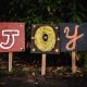 three assorted-color joy signage