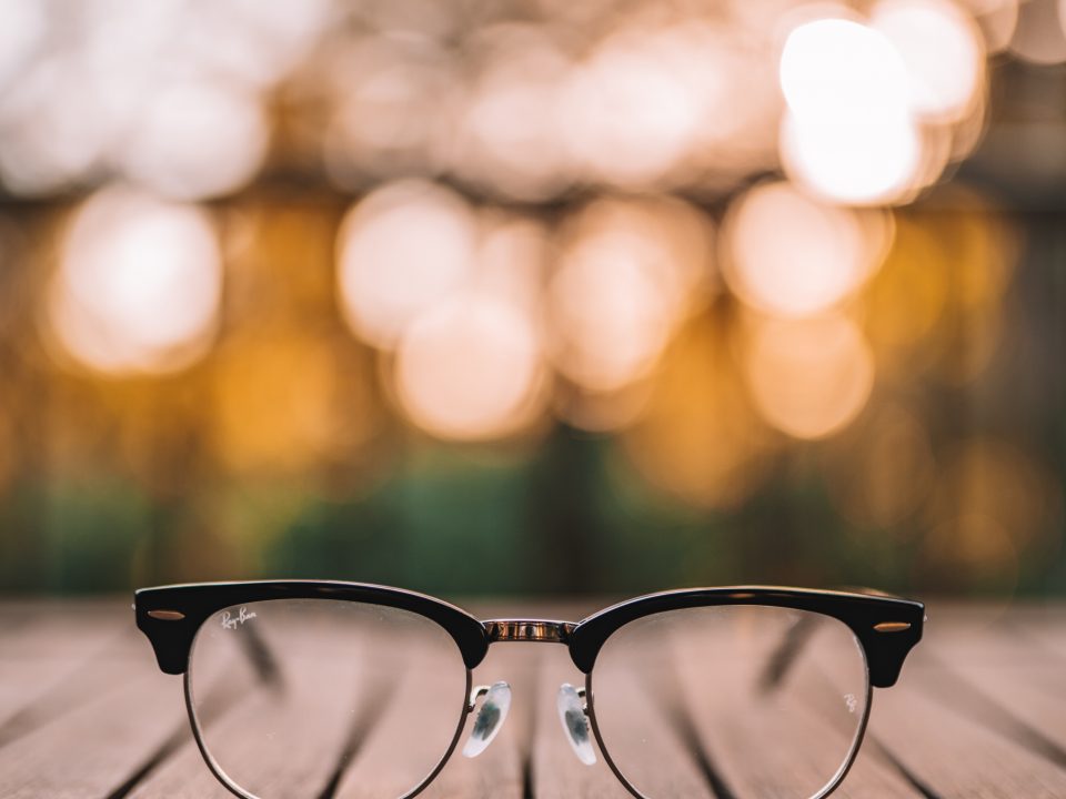 black framed eyeglasses on brown wooden table