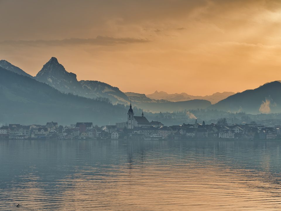 body of water near mountain during daytime