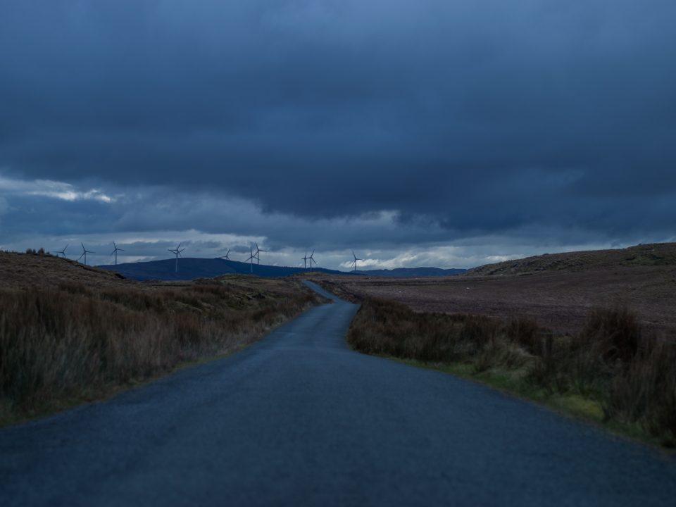 road going to field with wind turbines