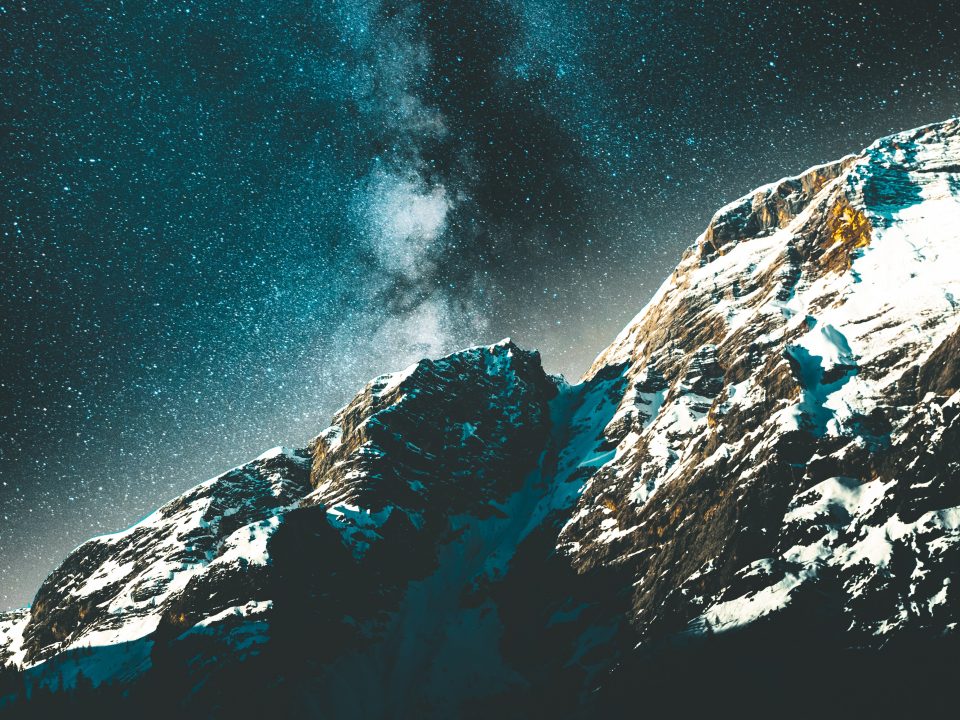 snow covered rocks at nighttime