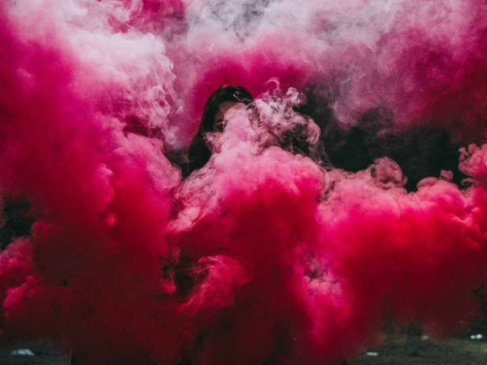 woman covered with pink smoke bomb