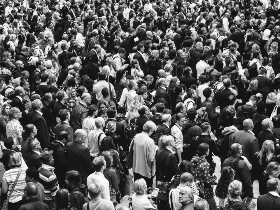 grascale photo of people standing on ground