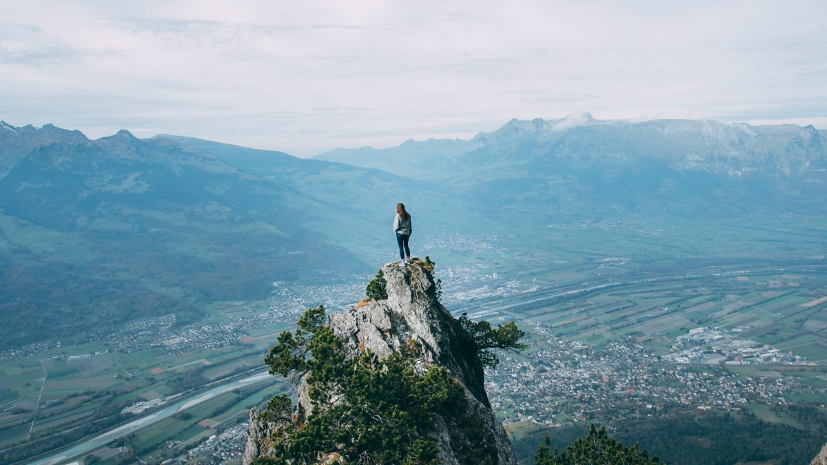 person standing on top of mountain