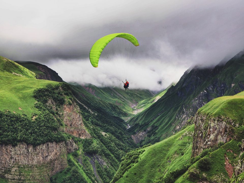 person paragliding near mountain range