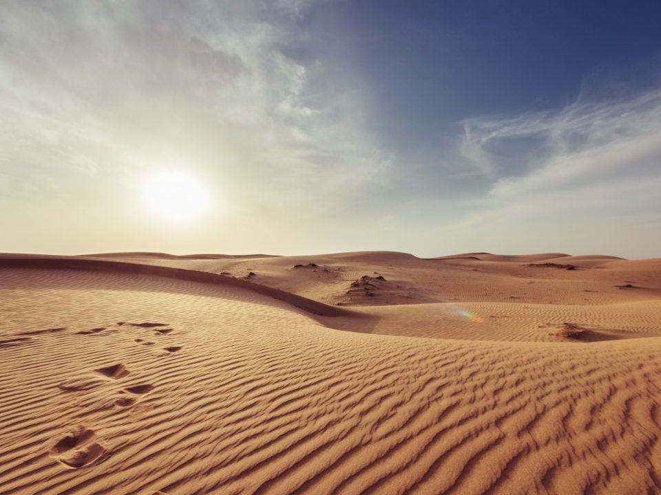 gray sand under white and blue sky