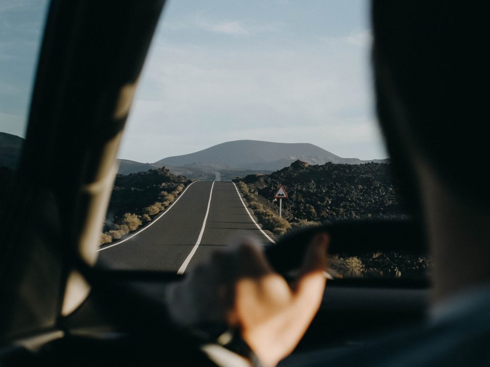 person driving a vehicle in the middle of the road