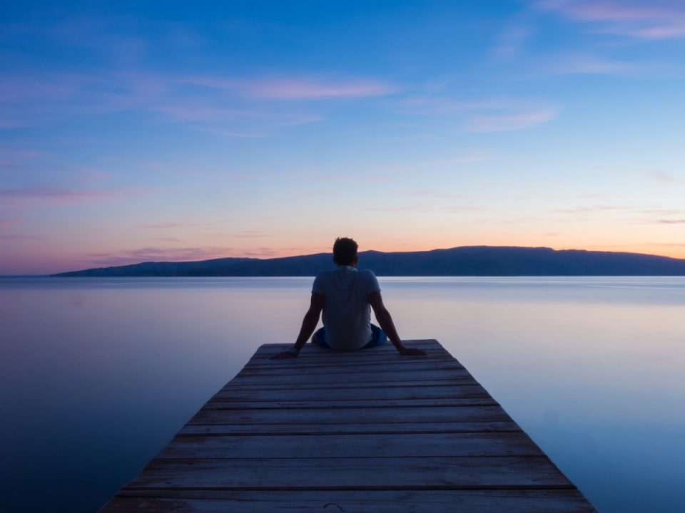 man siting on wooden dock