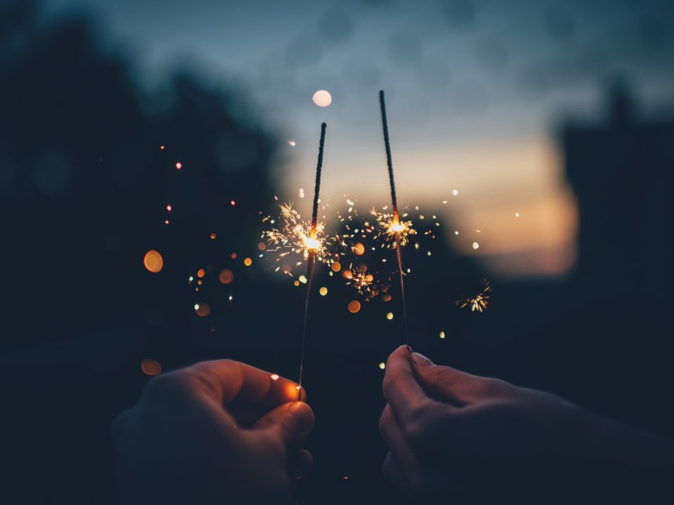 person holding fire cracker shallow focus photography