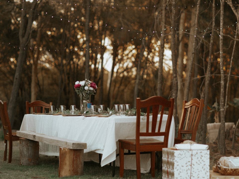 dining table and chairs set in the middle of the woods