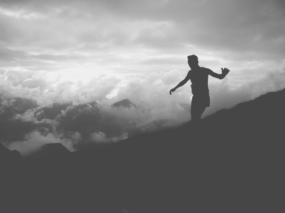 silhouette of man on mountain hill