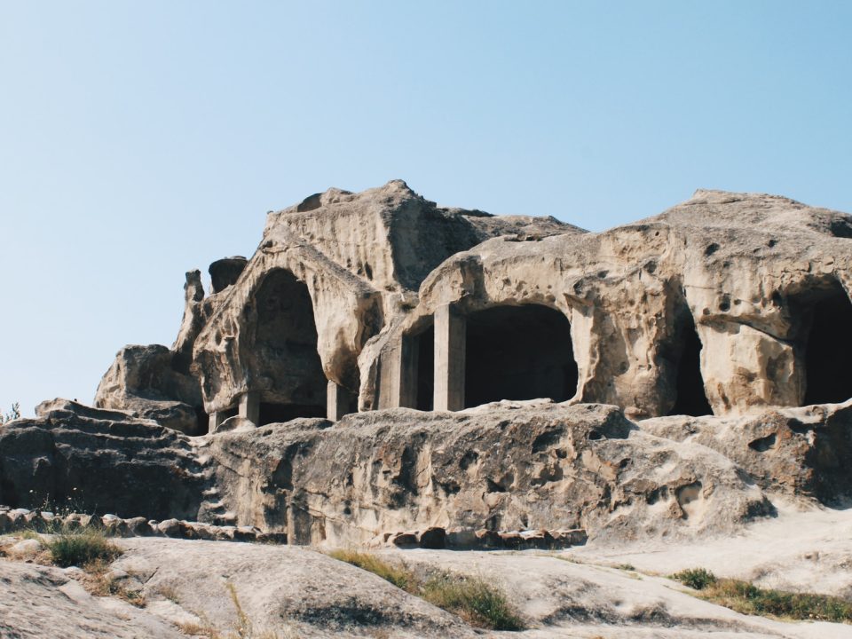 brown rock formation and cave