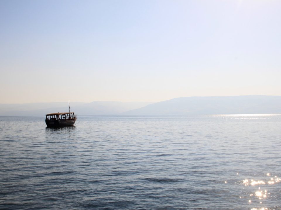 black boat on sea during daytime