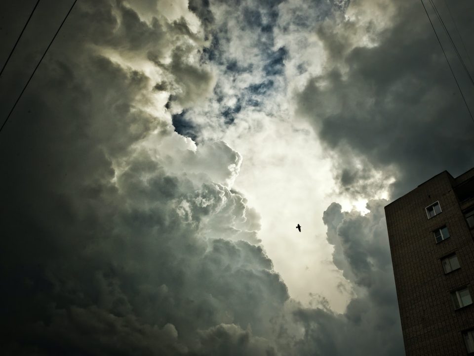 low angle photo of skyscraper under cloudy sky