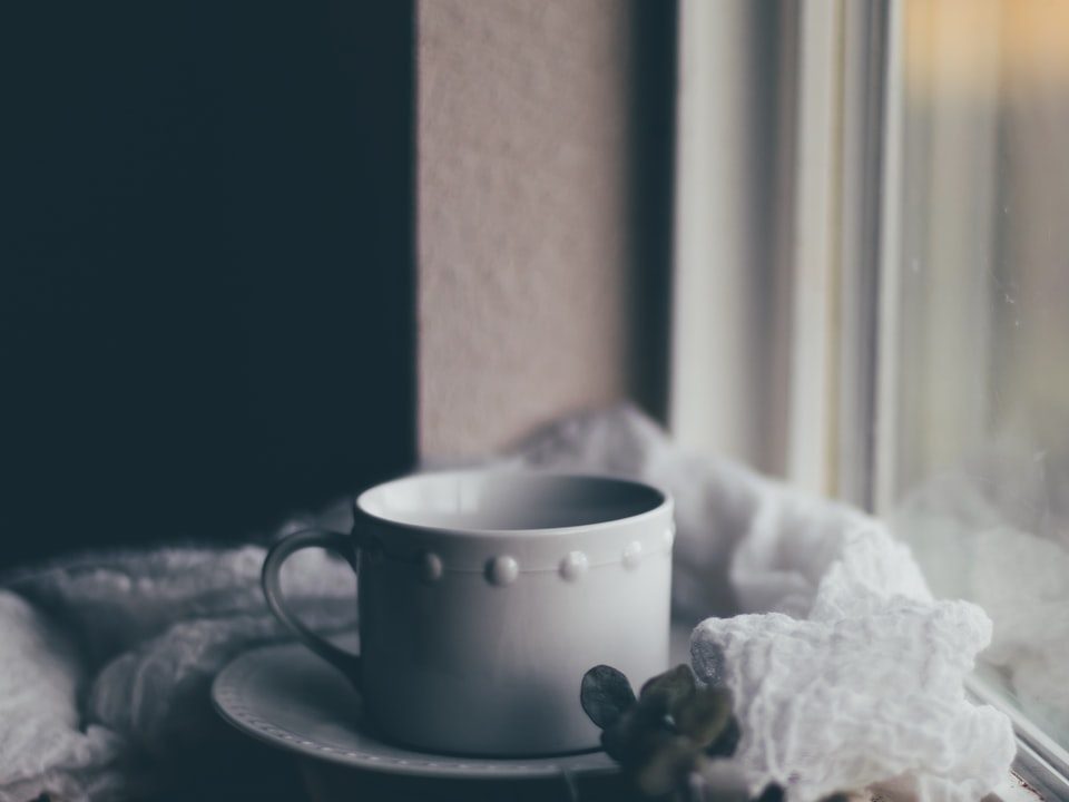 white ceramic teacup on saucer