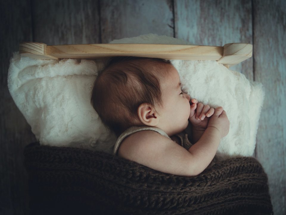 baby's sleeping on white comforter