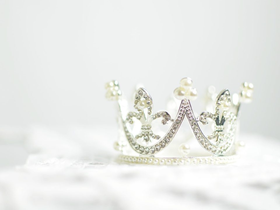 shallow photography of silver-colored crown