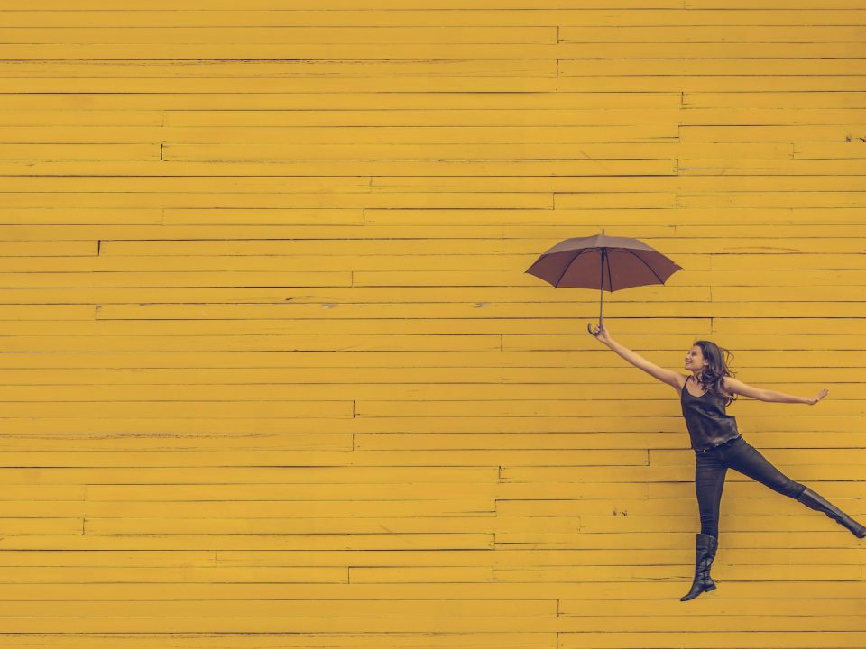 woman holding brown umbrella