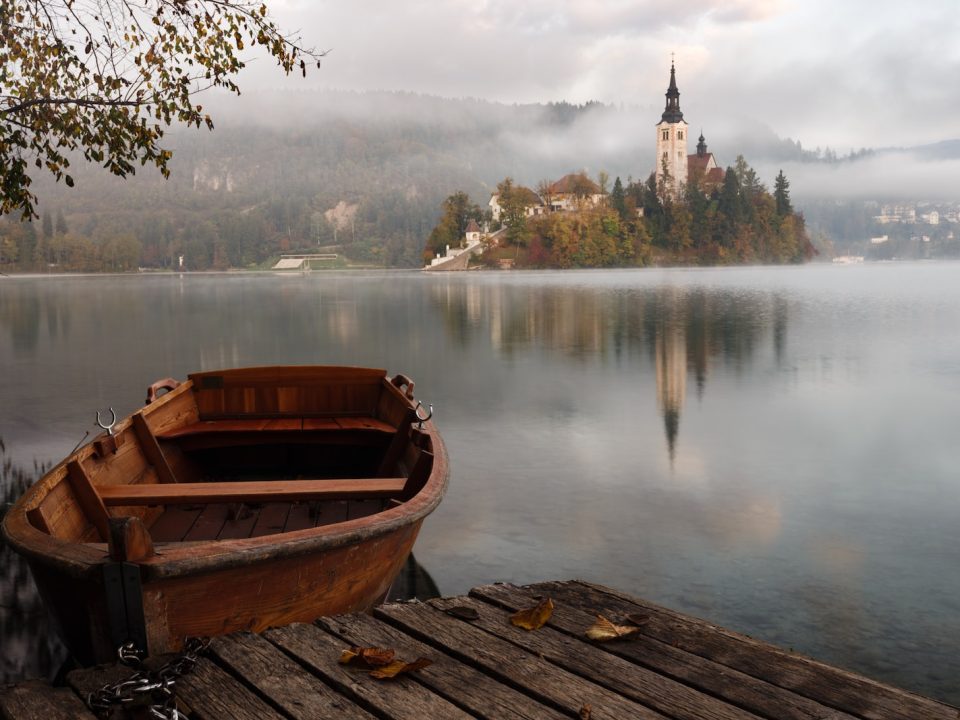 brown wooden boat floating on body of water