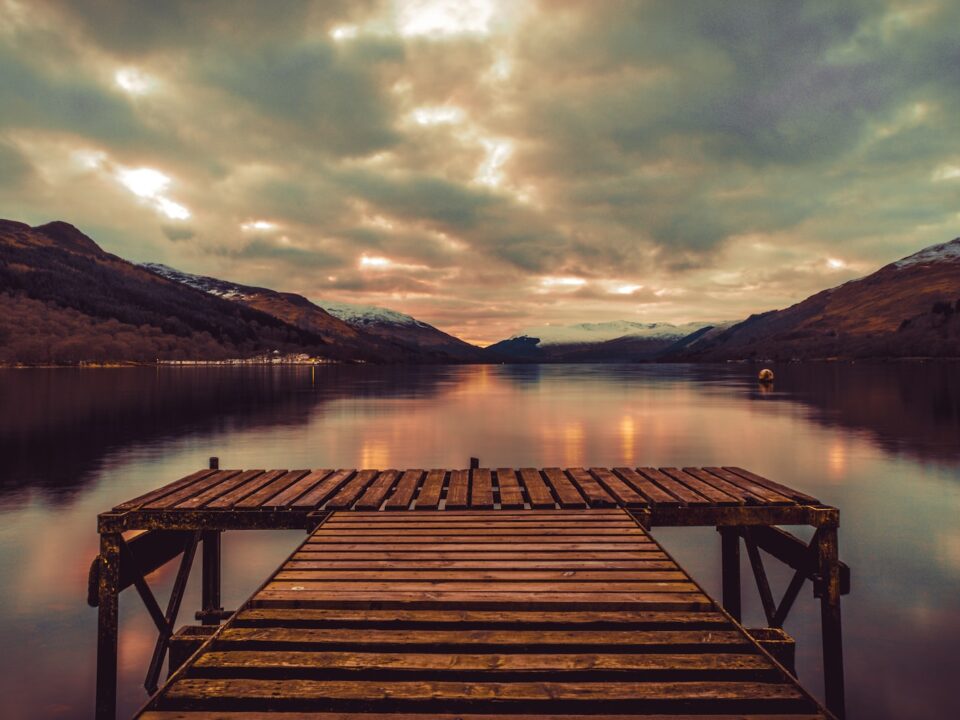 brown wooden dock on lake during daytime