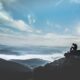 man sitting on rock during daytime