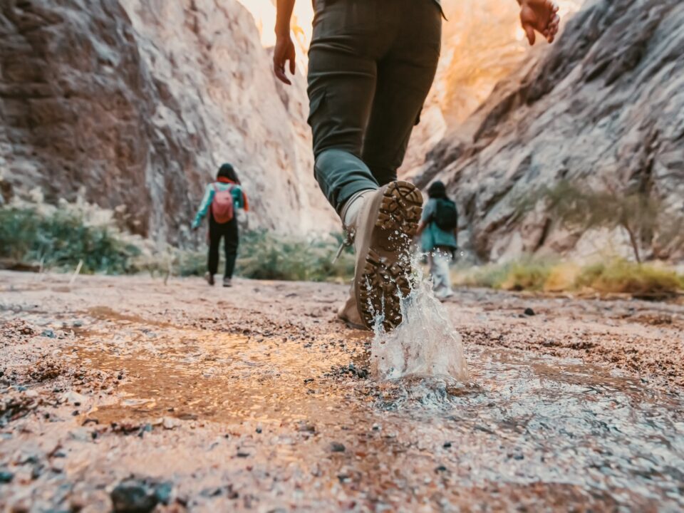 a couple of people that are walking in the dirt