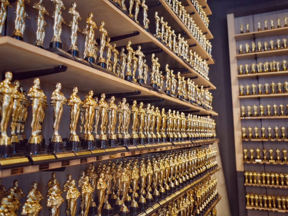 gold and silver trophy on brown wooden shelf