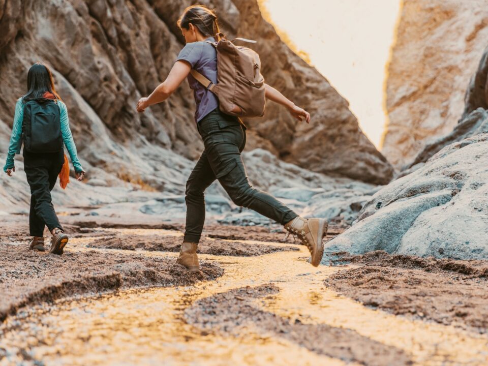 a couple of people that are walking in the dirt