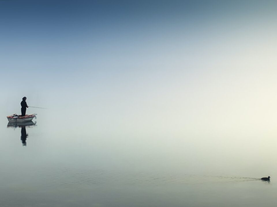 rule of thirds photography of man on boat