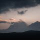 a view of a mountain with clouds in the sky