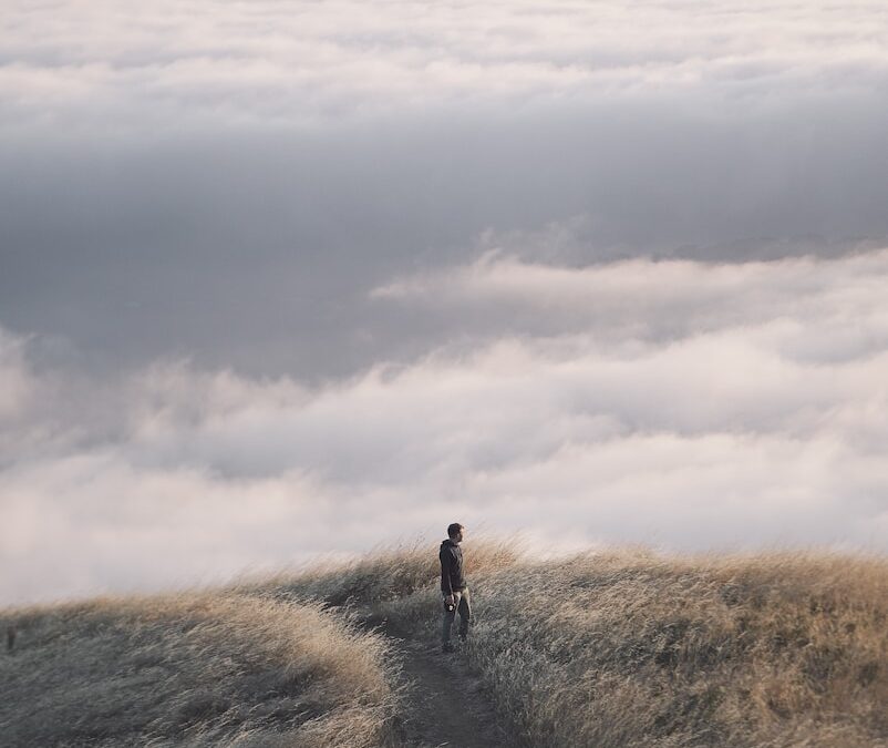 person near sea of clouds