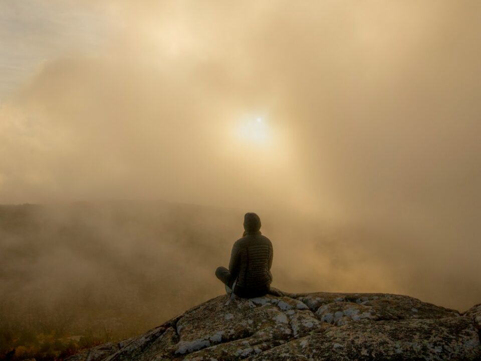 person sitting on rock during daytime