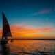silhouette photo of white sail boat