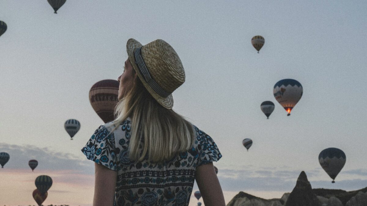 woman watching hot air balloons