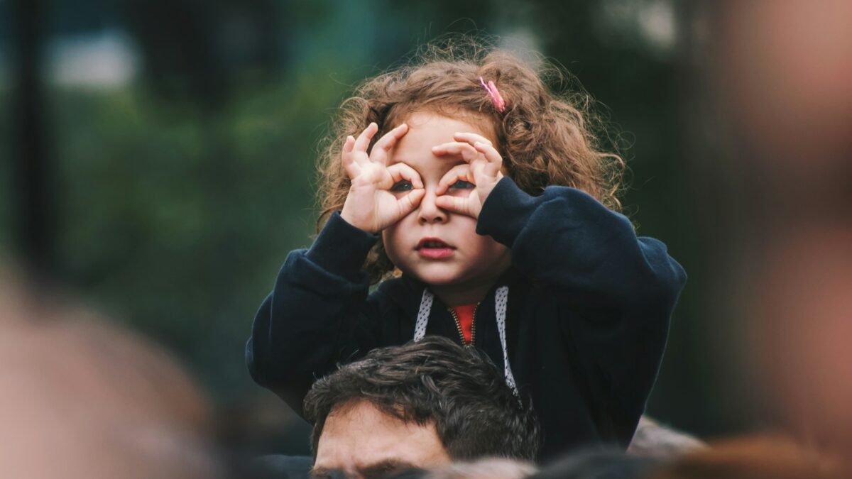 girl making hand gesture on her face