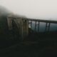 A foggy mountain with a bridge in the foreground