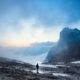 person standing near the cliff of the mountain