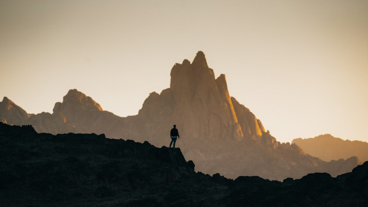 a person standing on top of a rocky hill