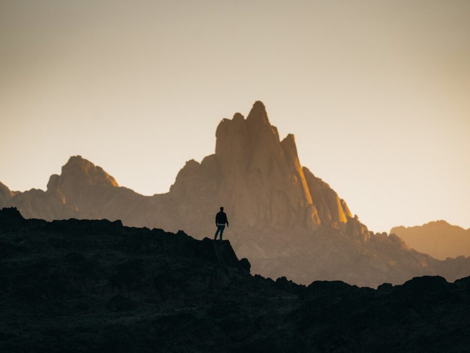 a person standing on top of a rocky hill