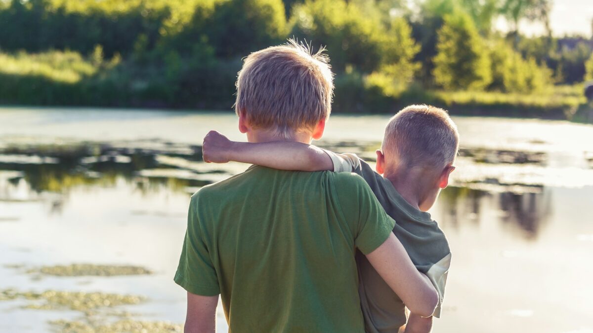 boy in green t-shirt standing beside boy in green t-shirt