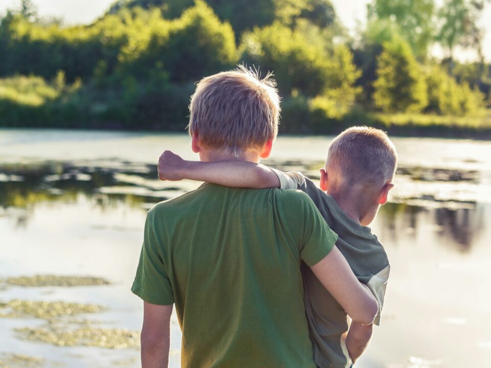 boy in green t-shirt standing beside boy in green t-shirt