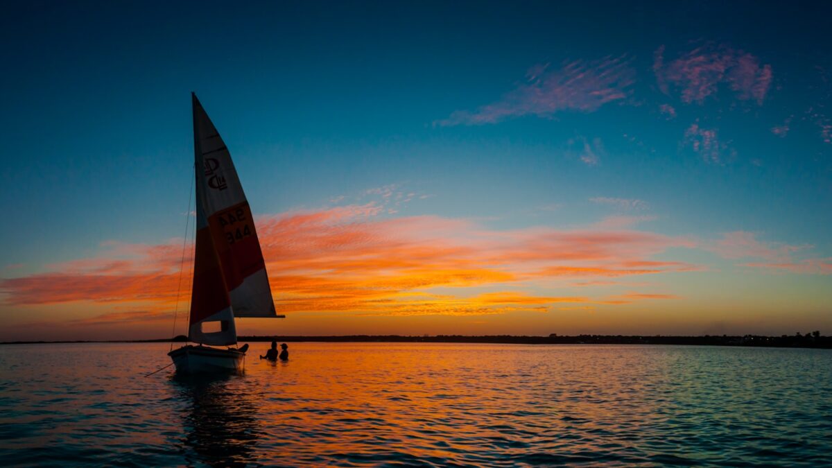 silhouette photo of white sail boat