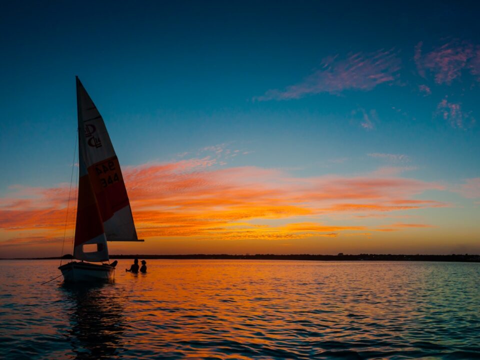 silhouette photo of white sail boat