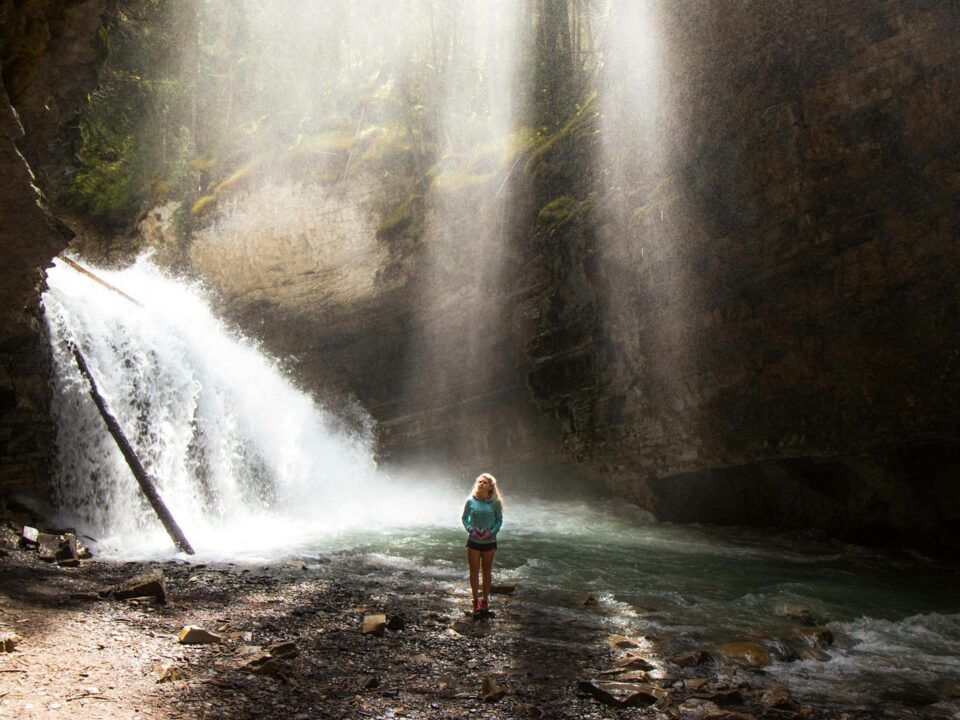 woman standing near river under gray sky during daytime