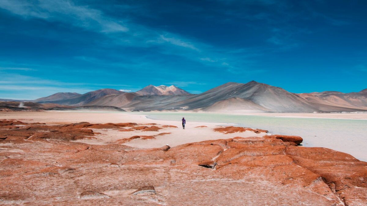 person walking in distance of mountain