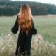 woman standing on green grass field during daytime